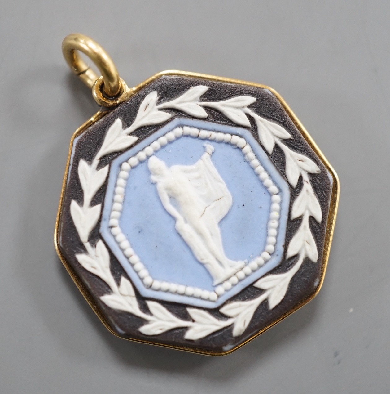 A late 19th/early 20th century yellow metal and two colour Wedgwood double sided octagonal pendant, 21mm.